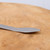 Close-up of the brushed stainless steel spatula end of the Tinyroots tool