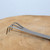 Close-up of the matte finished three pronged rake end of the Tinyroots tool