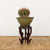 Dark mahogany cascade stand holding a pale green glazed pot with a bonsai