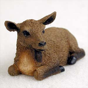 A detailed miniature figurine of a brown goat, designed as a decorative accent for a bonsai tree or terrarium. The goat is depicted in a resting pose, lying down with its legs tucked underneath its body. It features a realistic textured coat in varying shades of brown, with a lighter tan color on its chest. 

Notable details include a small dark beard hanging under its chin, dark hooves, a black nose, and expressive black eyes. The goat’s head is turned slightly to the right, giving it a peaceful and lifelike expression. This small, durable figurine is shown against a simple, off-white background, highlighting the intricate craftsmanship of the miniature animal.