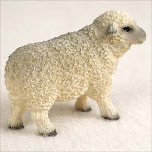 A small, detailed white sheep figurine designed as a miniature accessory for bonsai trees and indoor landscapes. The figurine depicts a standing sheep facing right, featuring a thick, highly textured coat of curly wool that covers its body. Its face, small ears, and legs are smoother in texture, with realistic gray and black accents painted on the hooves and around its eyes to add depth and character. The miniature animal is shown in profile against a simple, light-colored background, highlighting the craftsmanship and lifelike quality of the decorative bonsai figurine.
