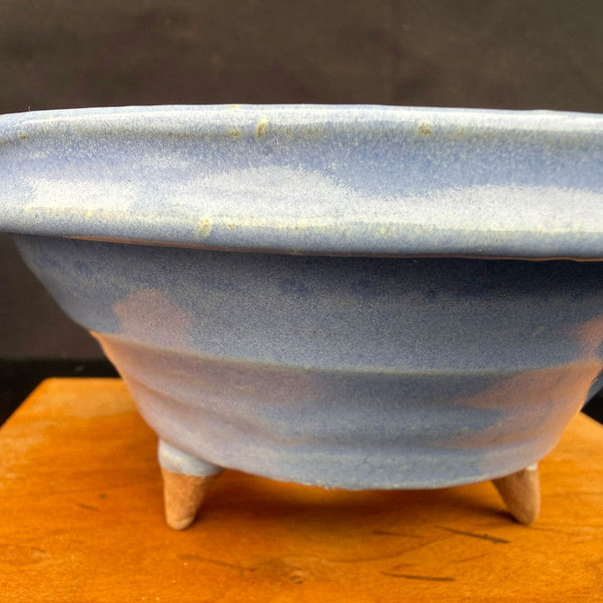 Kakuzan (Kakuyuki Watanabe) shohin bonsai pot close-up, sky-blue glaze with subtle banding, rolled rim detail and tapered feet