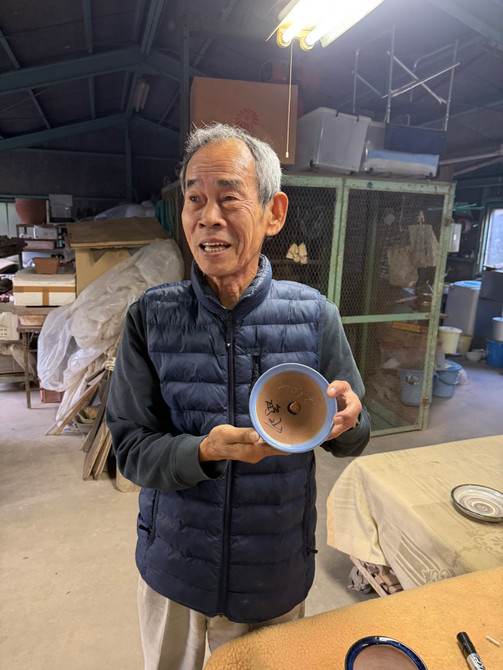 Kakuzan (Kakuyuki Watanabe) holding a hand-signed Tokoname bonsai pot at Kakuzan Toen, artist portrait in kiln studio