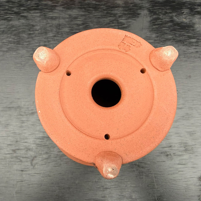 Underside of Kouji Watanabe Tokoname tall bonsai pot showing drainage hole, tie-down holes, and sculpted feet