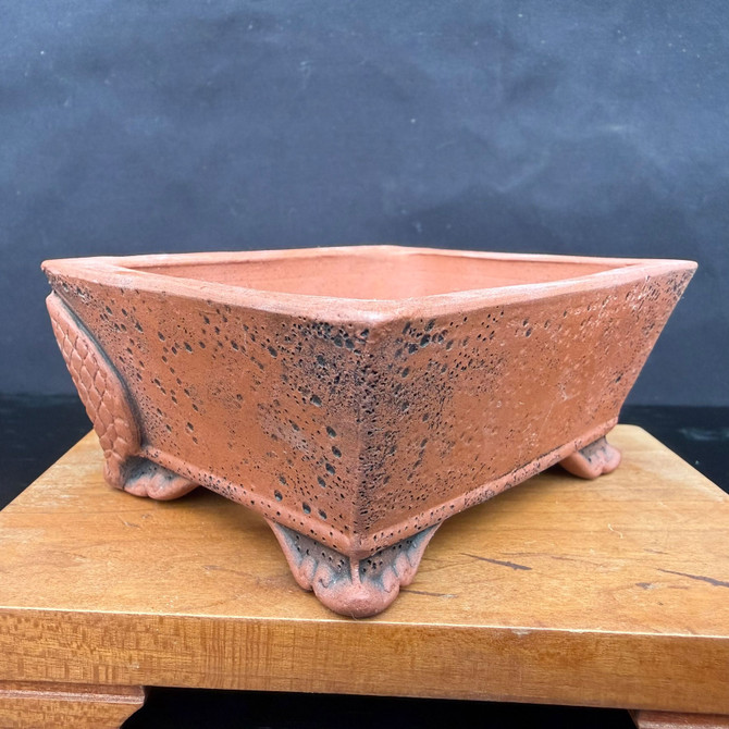 Angled view of Kouji Watanabe Tokoname rectangle bonsai pot showing dragon relief panel and raised sculpted feet