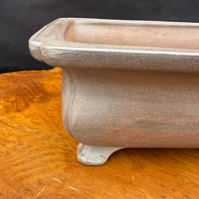 Close-up corner detail of Reiho unglazed rectangle bonsai pot showing broad rim and foot
