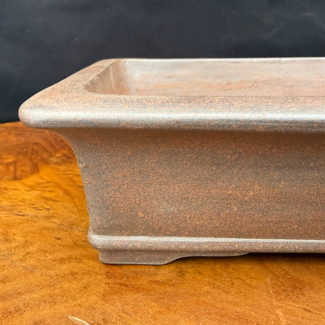 Close-up corner detail of Reiho unglazed rectangle bonsai pot showing soft flare and clay texture
