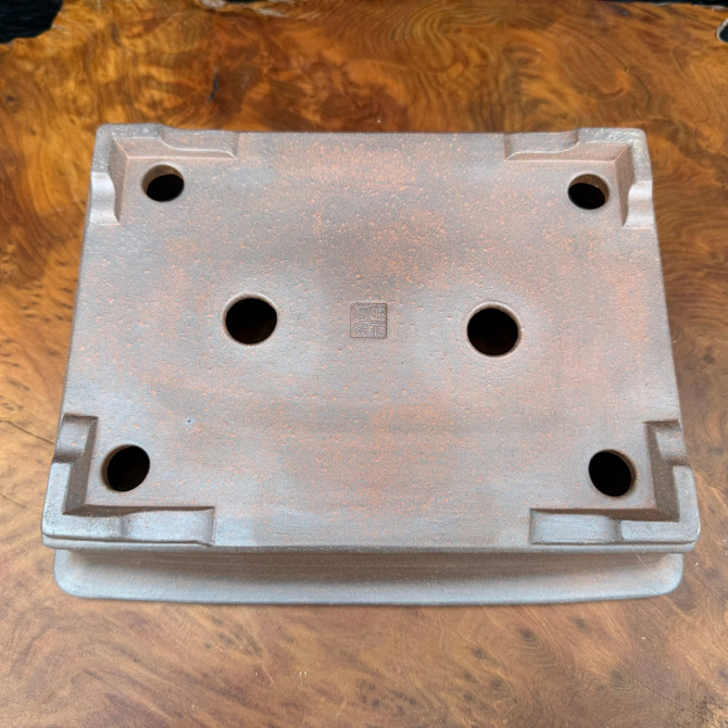 Underside view of Reiho Tokoname bonsai pot with artist chop and foot structure