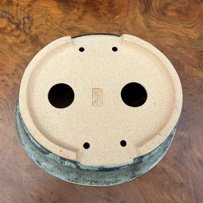 Underside view of Reiho Tokoname oval bonsai pot with artist chop and foot structure