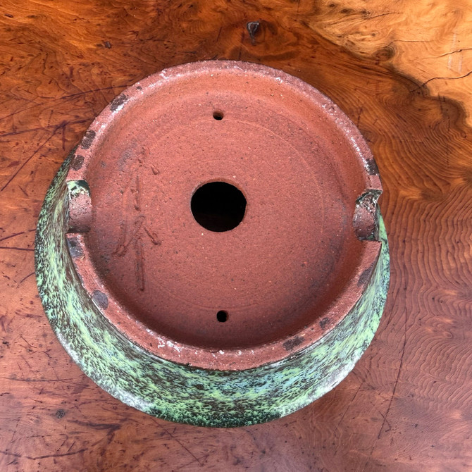 Bottom view of Shuho handmade bonsai pot showing base, feet, drainage hole, and artist chop