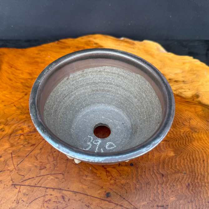 Top view of 5 inch round bonsai pot showing unglazed interior and single drainage hole
