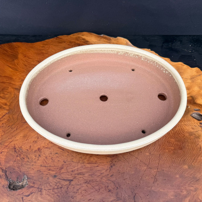 Top view of shallow Yamafusa oval bonsai pot showing drainage and tie-down holes