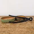 A detailed studio shot features a pair of Tinyroots black carbon steel concave cutters laid across two artisanal ceramic bonsai pots on a rustic wooden surface. 

On the left is a shallow, oval-shaped bonsai pot with a light green, speckled glaze and a decorative textured rim. Beside it sits a round, slightly deeper pot with a complex, hand-carved relief pattern in varying shades of dark green. Both pots reveal their raw, light-brown clay interior. 

Resting horizontally over the pots, the concave cutter—an essential part of any bonsai tool kit—displays its long, elegantly curved handles and sharp, matte-black cutting head. The Tinyroots brand name is subtly engraved on the upper handle. 

The composition is set against a plain, off-white background, highlighting the high-quality craftsmanship of both the carbon steel tools and the ceramic vessels. This image perfectly illustrates the professional components found in the Tinyroots Ultimate Package Carbon Steel Tool Kit.