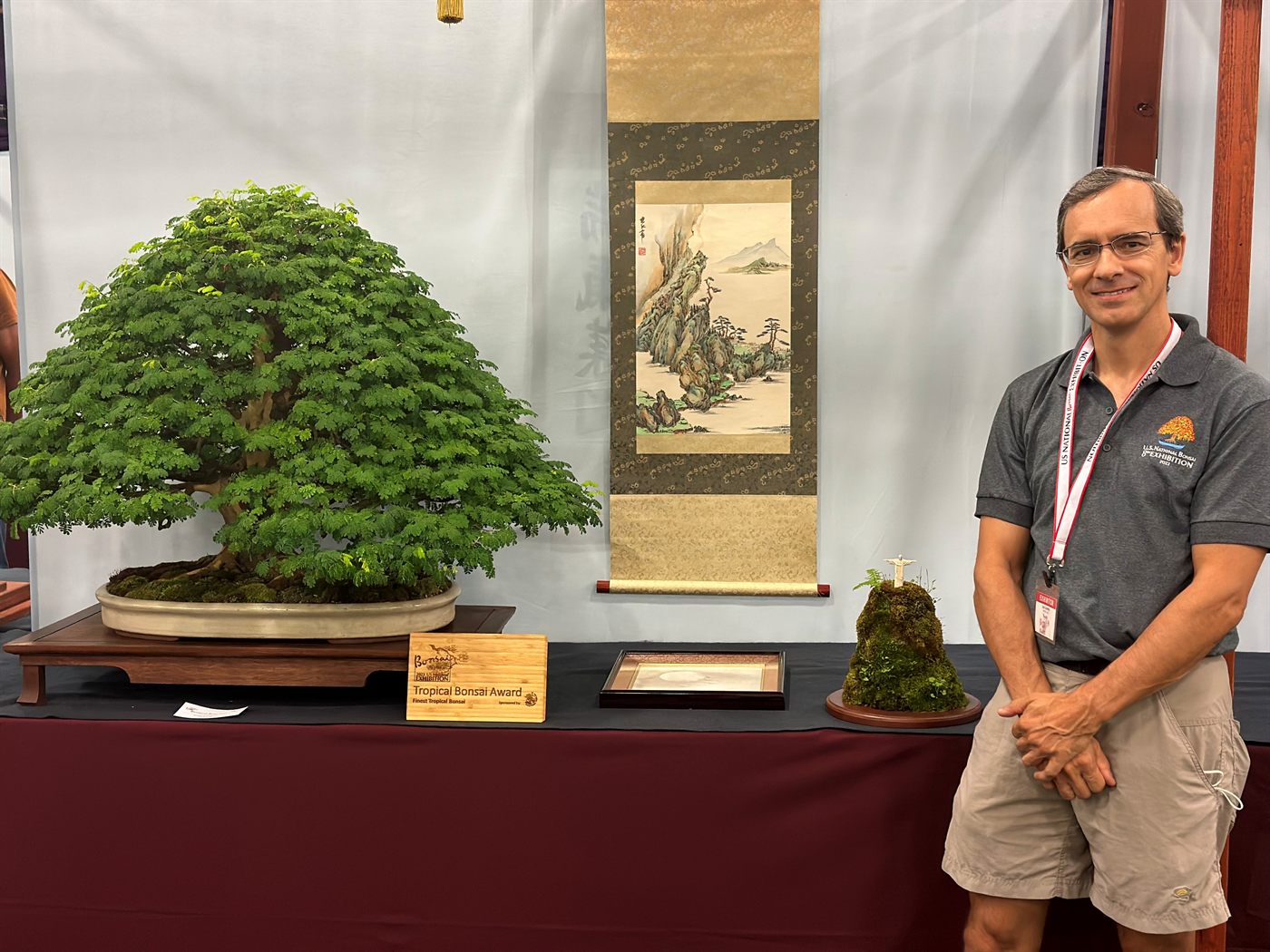 Lou Carreiro beside his award-winning Brazilian rain tree at the 2023 U.S. National Bonsai Exhibition