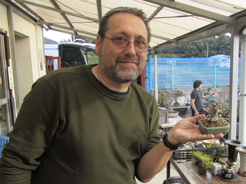 John Romano holding a mame bonsai