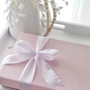 Pink gift box with white ribbon