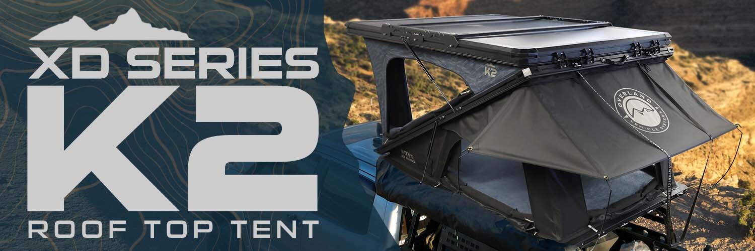 OVS XD K2 dual clamshell pop-up aluminum roof top tent deployed on vehicle overlanding setup