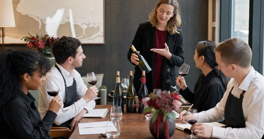 A wine educator leading a practical tasting session for hospitality staff