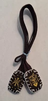 Small scapular with white embroidered edges.