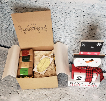 Gift box includes 4 - 4 oz. holiday scents soap bars and 1 full size exfoliating soap bar bag