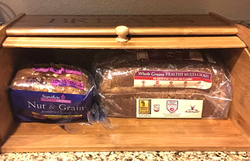 Bread box engraved with bread in it