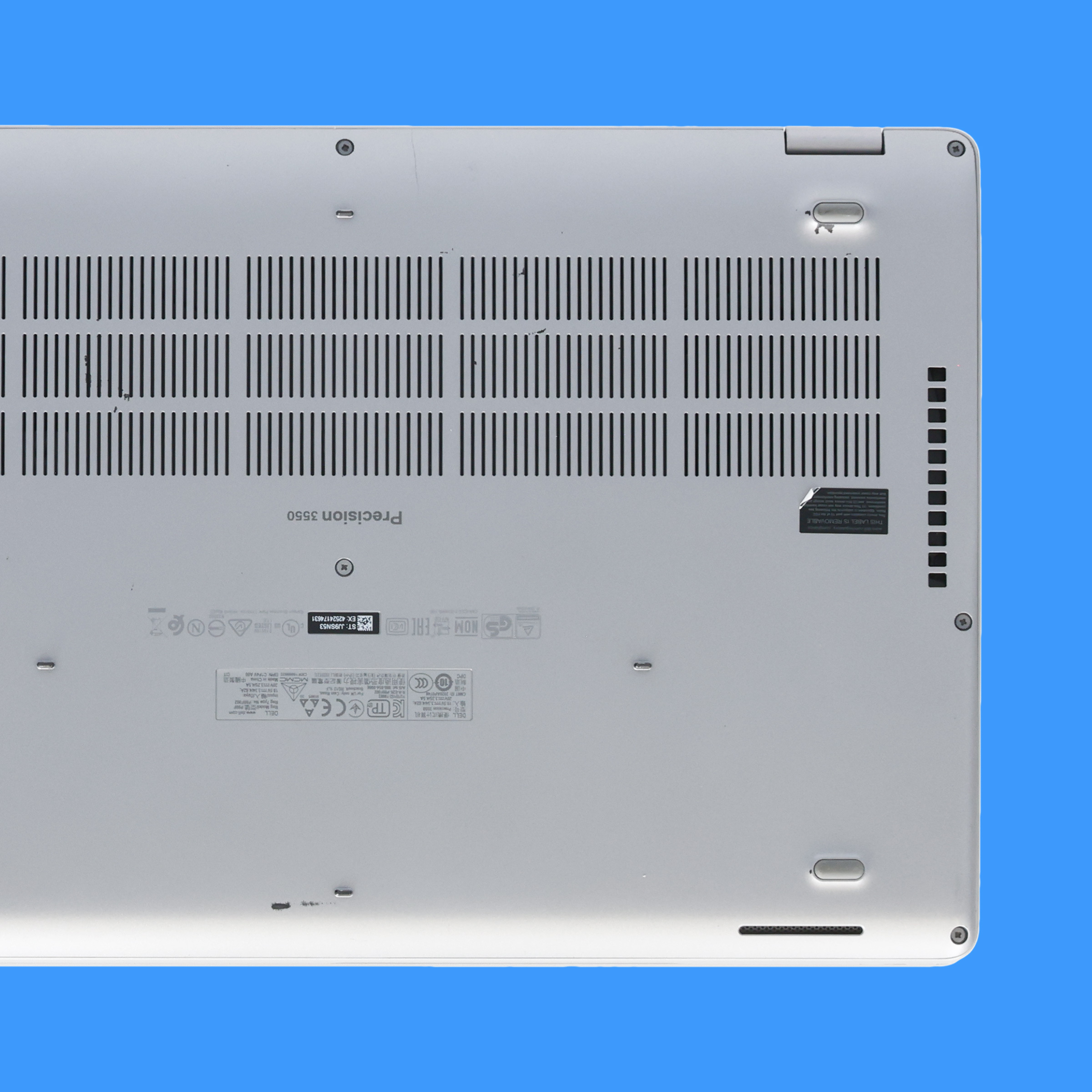 Lightly worn bottom of a Dell laptop