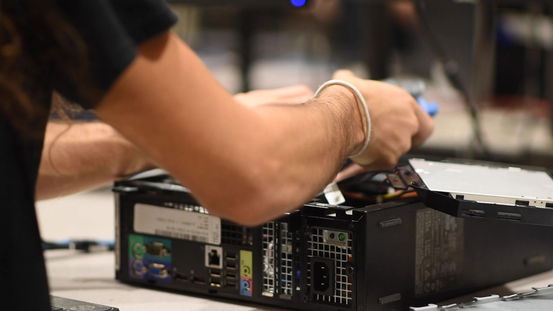 A BlairTech team member repairing a computer