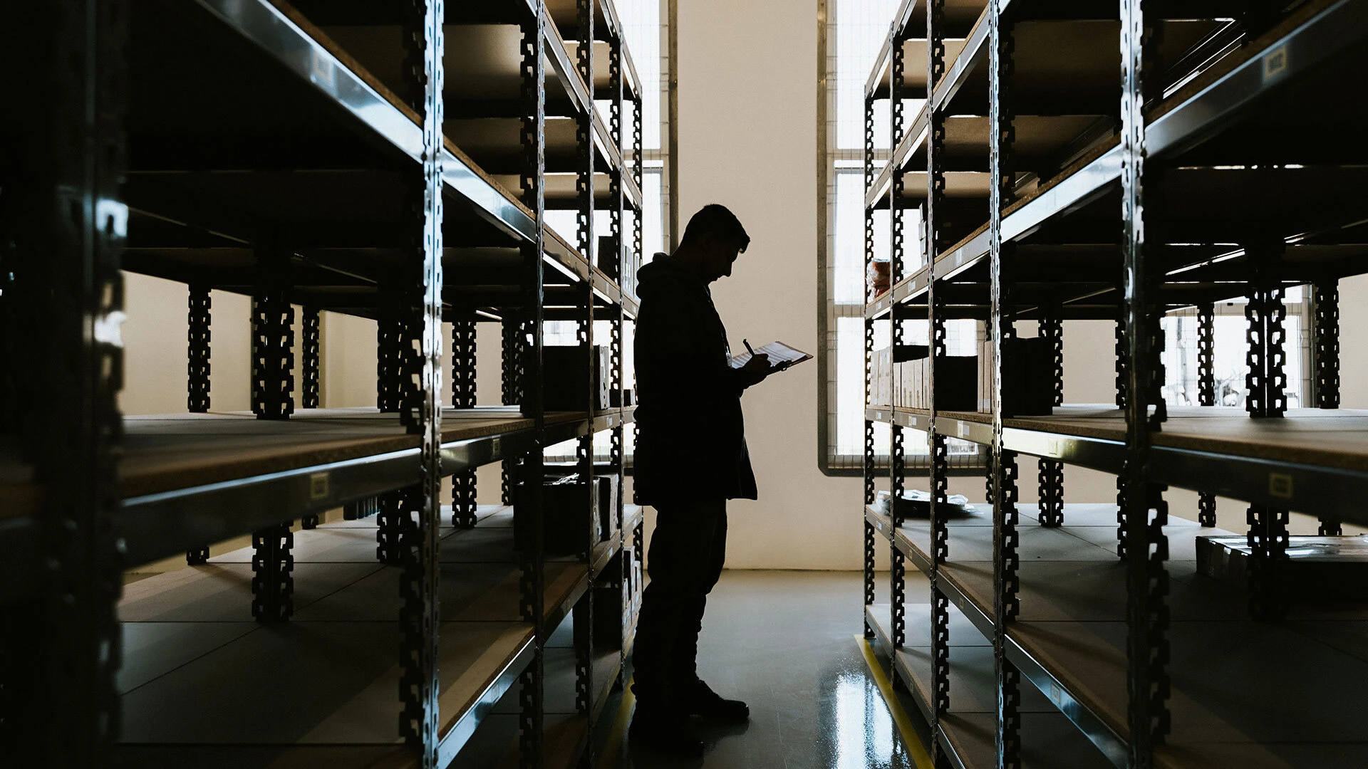 An employee looking at inventory in a warehouse