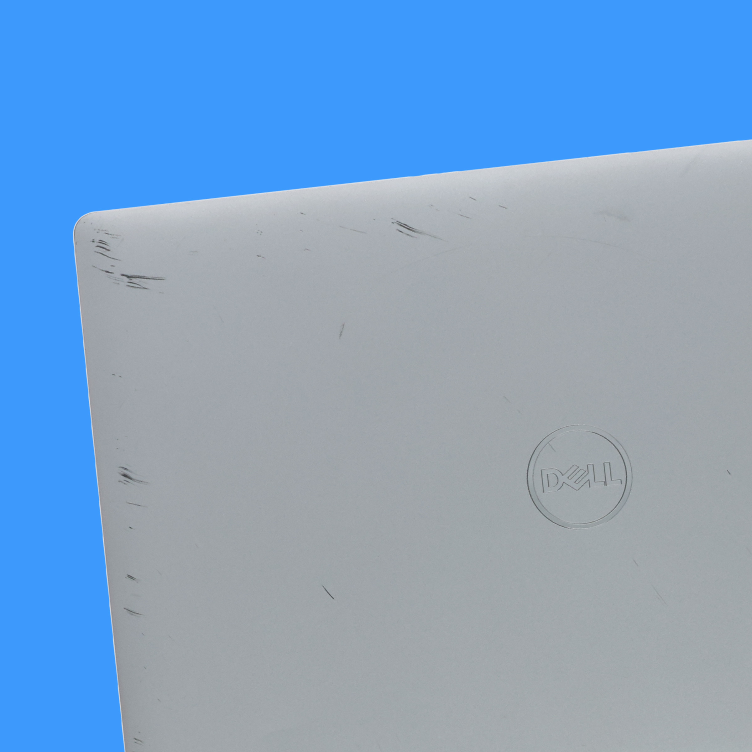 Scratches on the lid of a Dell laptop