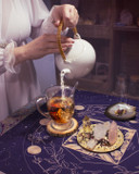 Pouring Tea from Moon Phase Ritual – Freshly steeped tea being poured into a cup during a ritual.