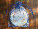 Selenite charging plate packaged in blue gift bag, ready for gifting or storage.