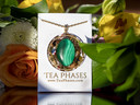 Malachite tea pendant displayed on Tea Phases branded card with floral background