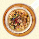 Goddess Grey black tea steeping in a glass teapot with colorful rose, cornflower, citrus and lemongrass visible.