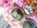 Handcrafted Green Labradorite tea pendant featuring natural iridescent flash, Mindful Green tea botanicals and gold details.