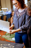 Amanda May demonstrating the Intuitivitea tea casting method and guidebook during an in-person intuitive reading.