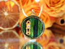 Handcrafted Gnome Door necklace featuring a hand-painted green pine wood door, gold keyhole and detachable miniature key.