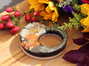 Autumn Alchemy botanical resin candle holder without candle, showing the center opening, pressed flowers and natural cork base.