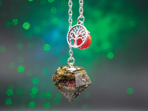 Radiant Soul pendulum with carnelian bead and silver tree of life charm, handmade with green tea leaves, rose petals, and silver leaf.