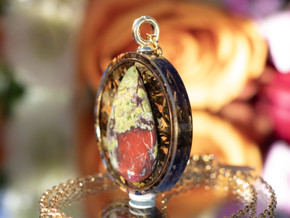 Side view of Dragon Blood Jasper tea-infused pendant showing layered eco resin and botanical infusion