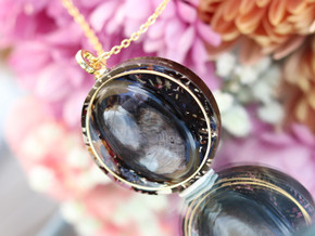 Handcrafted Hypersthene tea pendant featuring a dark reflective gemstone, Goddess Grey tea botanicals and gold details.