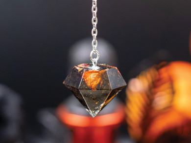 Handmade crystal pendulum crafted in Colorado, showcasing eco-resin infused with tea leaves and petals. Ideal for spiritual seekers using pendulums for guidance and energy cleansing.