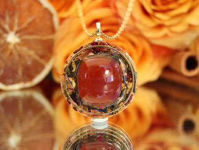 Life Force Energy tea-infused pendant featuring AAA Carnelian, white tea, botanicals and gold accents in clear resin.
