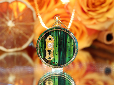Handcrafted Gnome Door necklace featuring a hand-painted green pine wood door, gold keyhole and detachable miniature key.