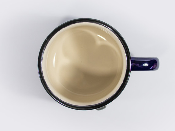 Overhead view of mug opening, showcasing white glazed interior and black rim.