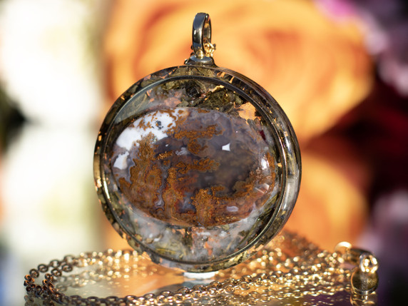 Close-up of I AM Grounded pendant featuring AAA Moss Agate set in gold inset ring