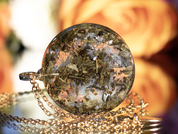 Back view of green tea leaves and mineral textures suspended in clear resin