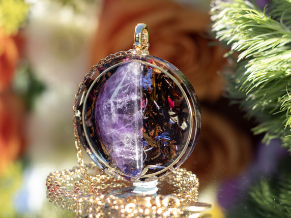 Close-up of I AM Awakened pendant featuring AAA amethyst split within gold inset ring