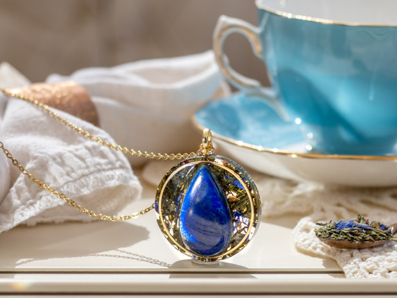 I OWN MY TRUTH pendant featuring a AAA Lapis Lazuli set in green tea leaves with a gold inset ring.