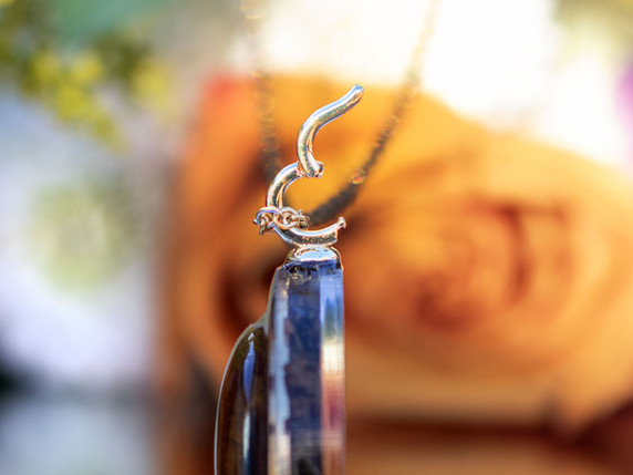 Detail of 14k gold-filled snap latch bail attached to round pendant