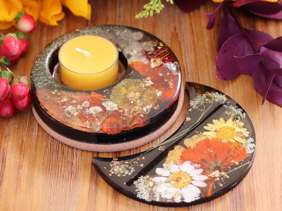 Coordinating botanical candle and tarot card holders with red, yellow and white pressed flowers, metallic leaf and black resin.